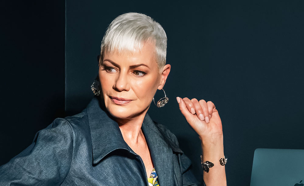 Marna standing next to a laptop