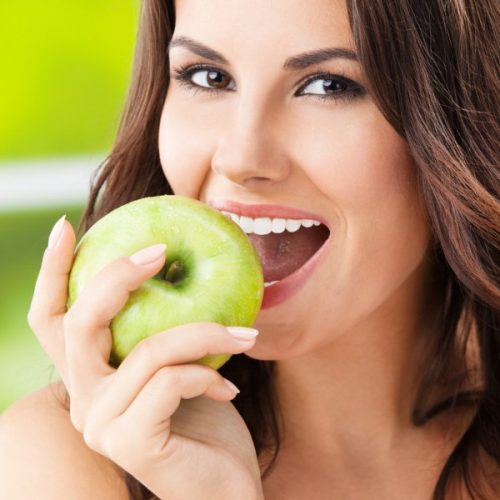 depositphotos_28812991-stock-photo-young-woman-eating-apple-outdoors